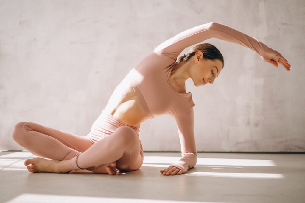 mujer haciendo yoga postura estiramiento luz natural